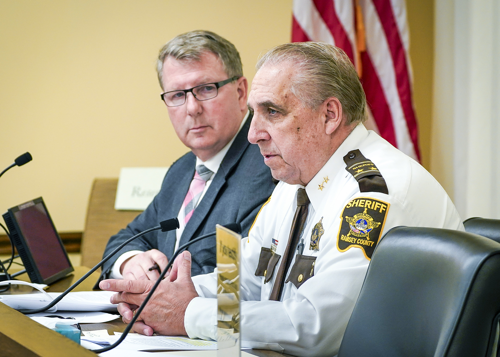 Ramsey County Sheriff Bob Fletcher testifies before the House Public Safety Finance and Policy Committee during a Jan. 22 discussion of a crime bill sponsored by Rep. Paul Novotny, left. (Photo by Andrew VonBank)